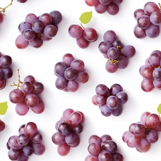 A pattern of purple grapes arranged on a white background